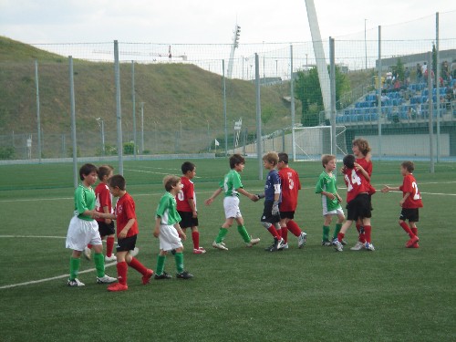 Los dos equipos se dan la mano deportivamente al final del partido